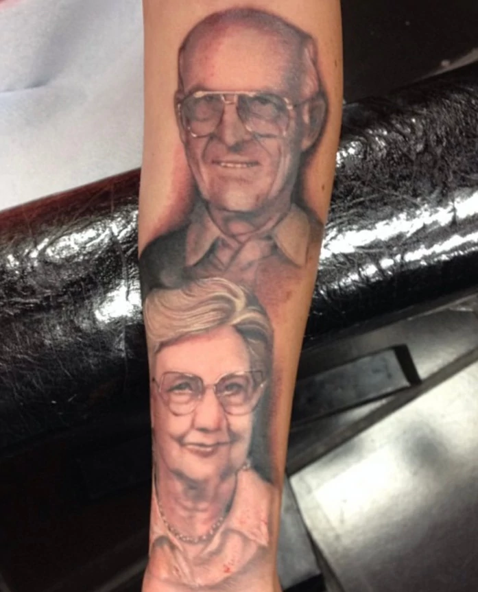 Portrait forearm tattoo of grandparents done in black and grey ink by tattoo artist Russ Howie of Sacred Mandala Studio in Durham, NC.